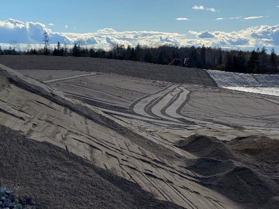 Geomembrane well protected over and under with clean sand